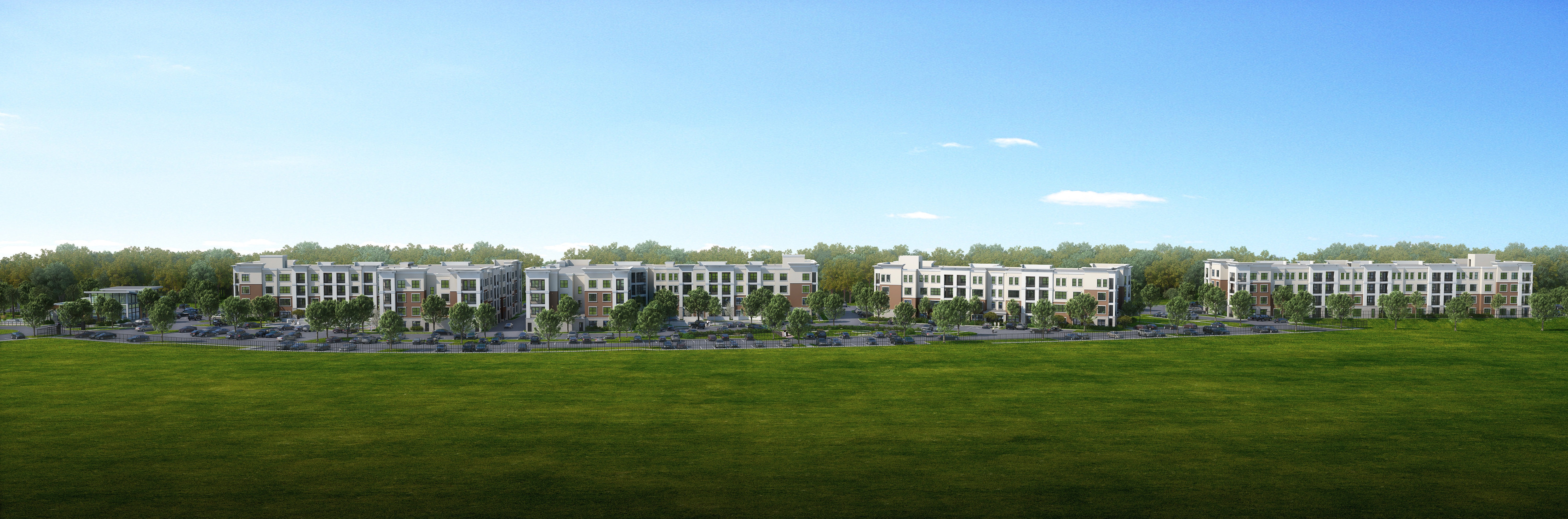 A large grassy field with a row of buildings in the distance at Manor East Apartments, Manor, 78653